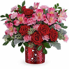Red roses and pink alstroemeria in a red heart-patterned vase