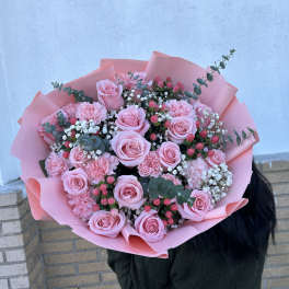 Pink rose bouquet with carnations and baby's breath in pink wrap