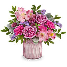 Pink and purple flower arrangement in a glass vase