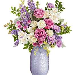 Pink and white rose bouquet in a lavender vase