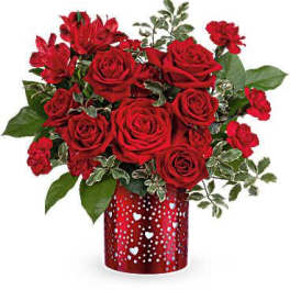 Red roses and carnations in a heart-patterned red vase