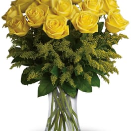 Yellow roses arranged in a clear glass vase