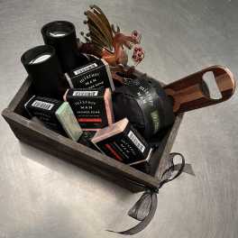 Gift basket with shower bombs, candles, and a metal dragon ornament