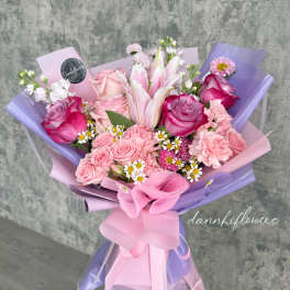 Pink and lavender bouquet with roses, lilies, and small daisies