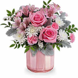 Pink roses and mixed flowers in a pink glass vase