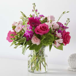 Pink mixed flower bouquet in a clear glass vase