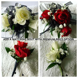 Boutonnieres with roses, baby's breath, and black ribbon accents