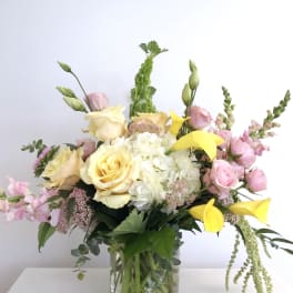 Bouquet of yellow and pink flowers in a glass vase