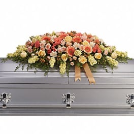 Large pastel floral casket spray on a gray casket
