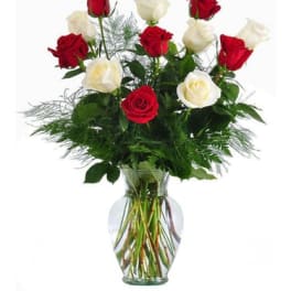 Red and white roses in a clear glass vase