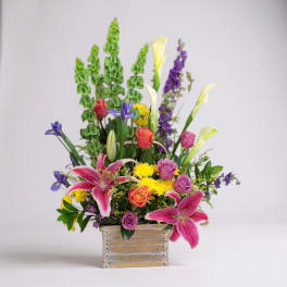 Colorful mixed flower arrangement in a rectangular container