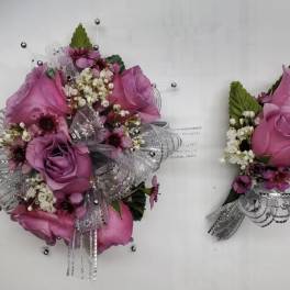 Pink rose corsage and matching boutonniere with silver ribbon