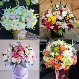 Four mixed rose bouquets in decorative boxes and buckets