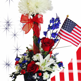 Red, white, and blue floral arrangement with an American flag