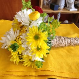 Bouquet of yellow and white daisies wrapped with twine