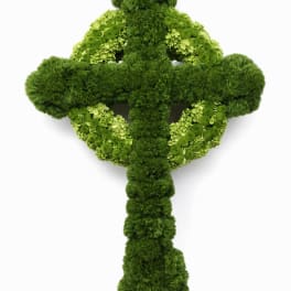 Green floral cross made of mossy blooms and hydrangeas