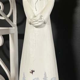 White angel figurine with blue floral painting and wings