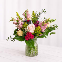 Mixed pink and white flowers in a clear glass vase