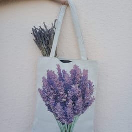Canvas tote bag with a lavender bouquet print and dried lavender stems peeking out