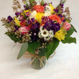 Mixed bouquet of colorful flowers in a glass vase