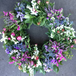 Circular floral wreath with purple, pink, and white blooms