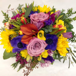 Mixed bouquet with roses, calla lilies, and bright daisies
