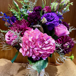 Bouquet of pink and purple flowers in a glass vase