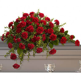 Red carnation arrangement on a gray casket
