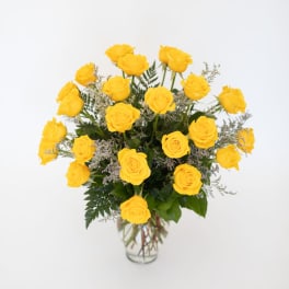 Yellow roses arranged in a clear glass vase