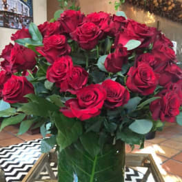 Large bouquet of red roses in a glass vase