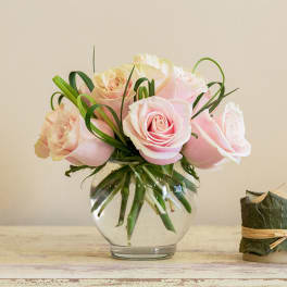 Pink roses arranged in a clear glass vase