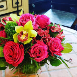 Bouquet of pink roses and yellow orchids with greenery