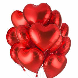 Cluster of red heart-shaped balloons on white background