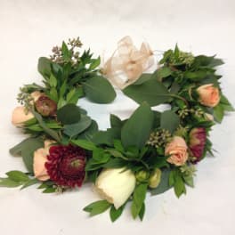 Floral wreath with peach and burgundy blooms and a sheer ribbon bow