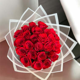 Bouquet of red roses wrapped in clear geometric paper