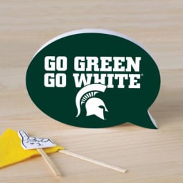 Green speech bubble sign with white text and a small yellow pennant
