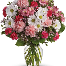Pink and white mixed bouquet in a clear glass vase