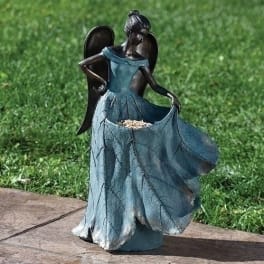Decorative angel figurine in a blue dress holding a leaf-shaped bowl