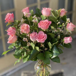 Pink roses arranged in a clear glass vase