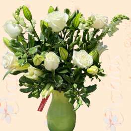 White roses and lily buds in a green vase
