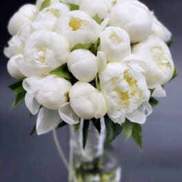 White peony bouquet in a clear glass vase