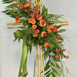 Cross-shaped floral standing spray with orange and red blooms