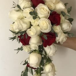 Bouquet of red and white roses with eucalyptus greenery
