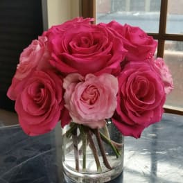 Pink roses arranged in a clear glass vase