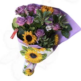 Bouquet of purple roses and yellow sunflowers wrapped in lavender paper