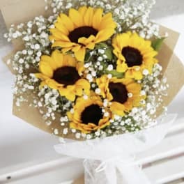 Bouquet of sunflowers with baby's breath wrapped in brown paper