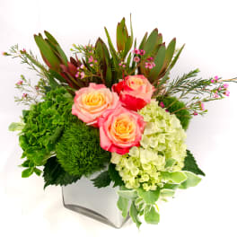Pink roses and green hydrangeas in a white square vase
