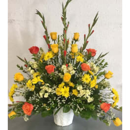 Yellow and orange rose arrangement in a white vase