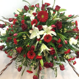 Large red and white floral spray with roses, lilies, and gerbera daisies