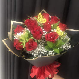 Bouquet of red roses with baby’s breath and gold butterfly picks